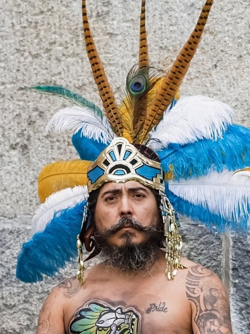 Mundo Santillan seated on green grass holding copal in ceremony