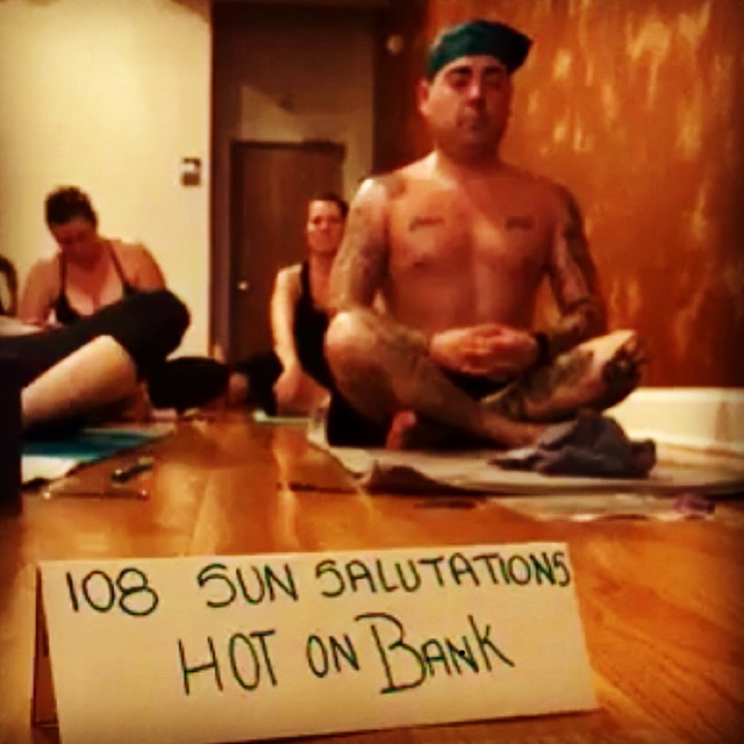 Seated in stillness after 108 sun salutations — the body at rest inside the practice.