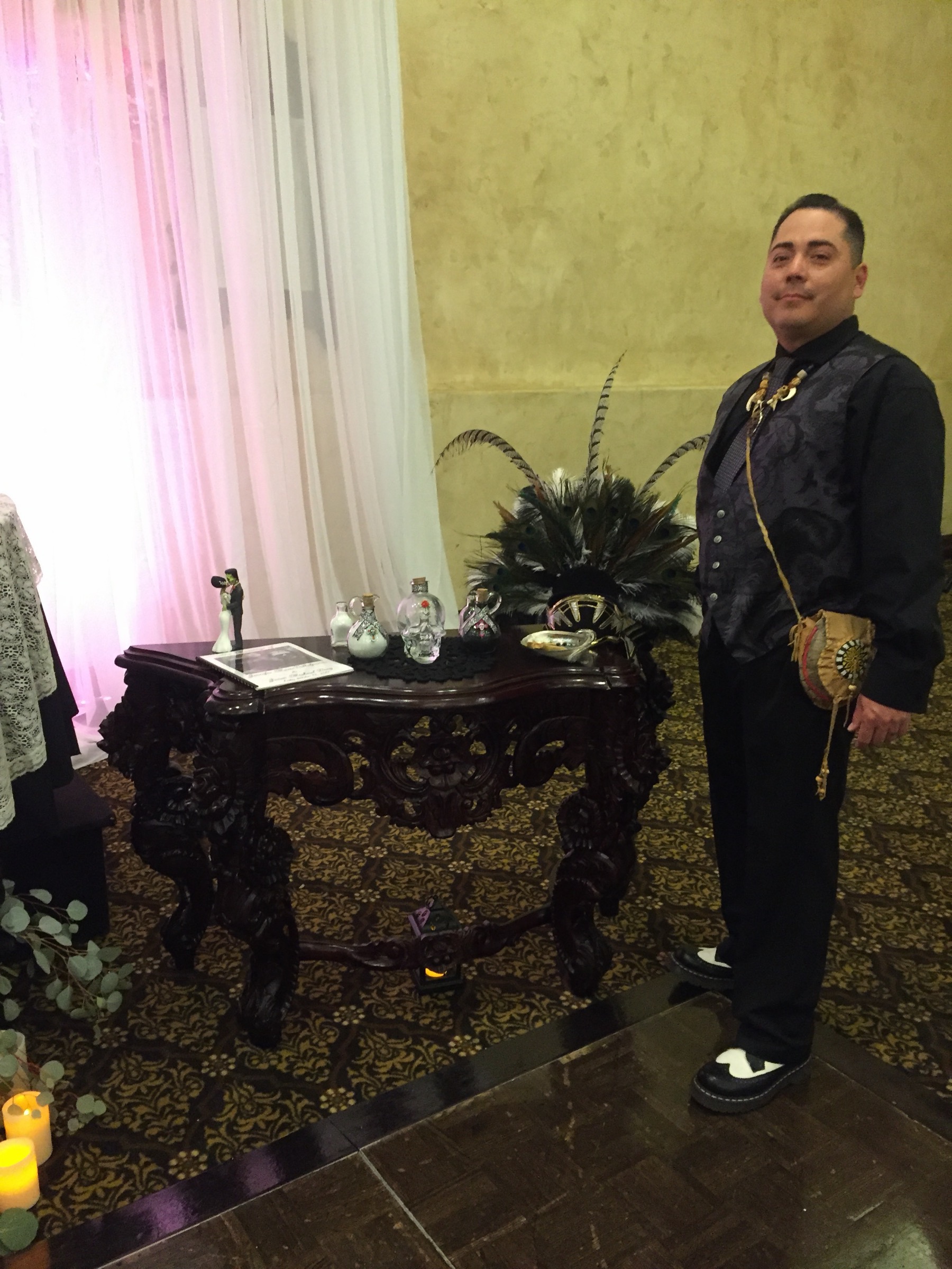 A wedding altar dressed with sacred objects and the ceremonial robe — the threshold prepared before anyone crosses.